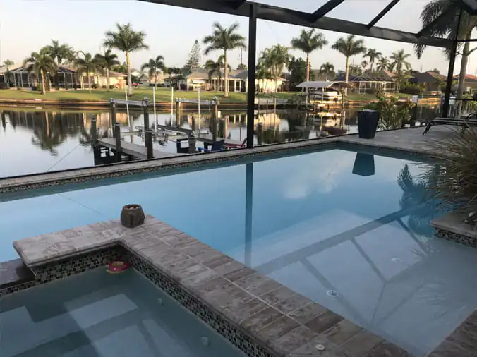 Private covered swimming pool with palm trees in the background