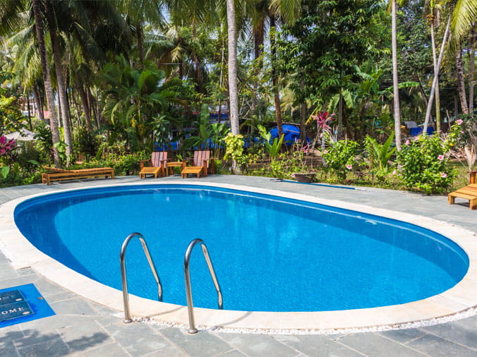 Oval shaped backyard swimming pool