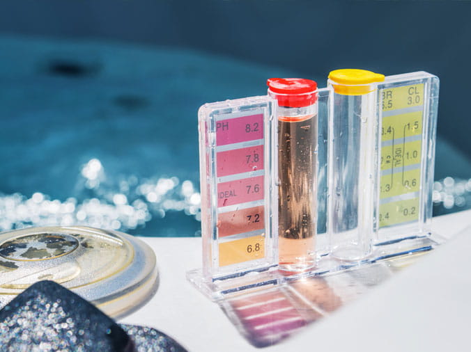 Closeup of a pool testing kit with pool testing chemicals
